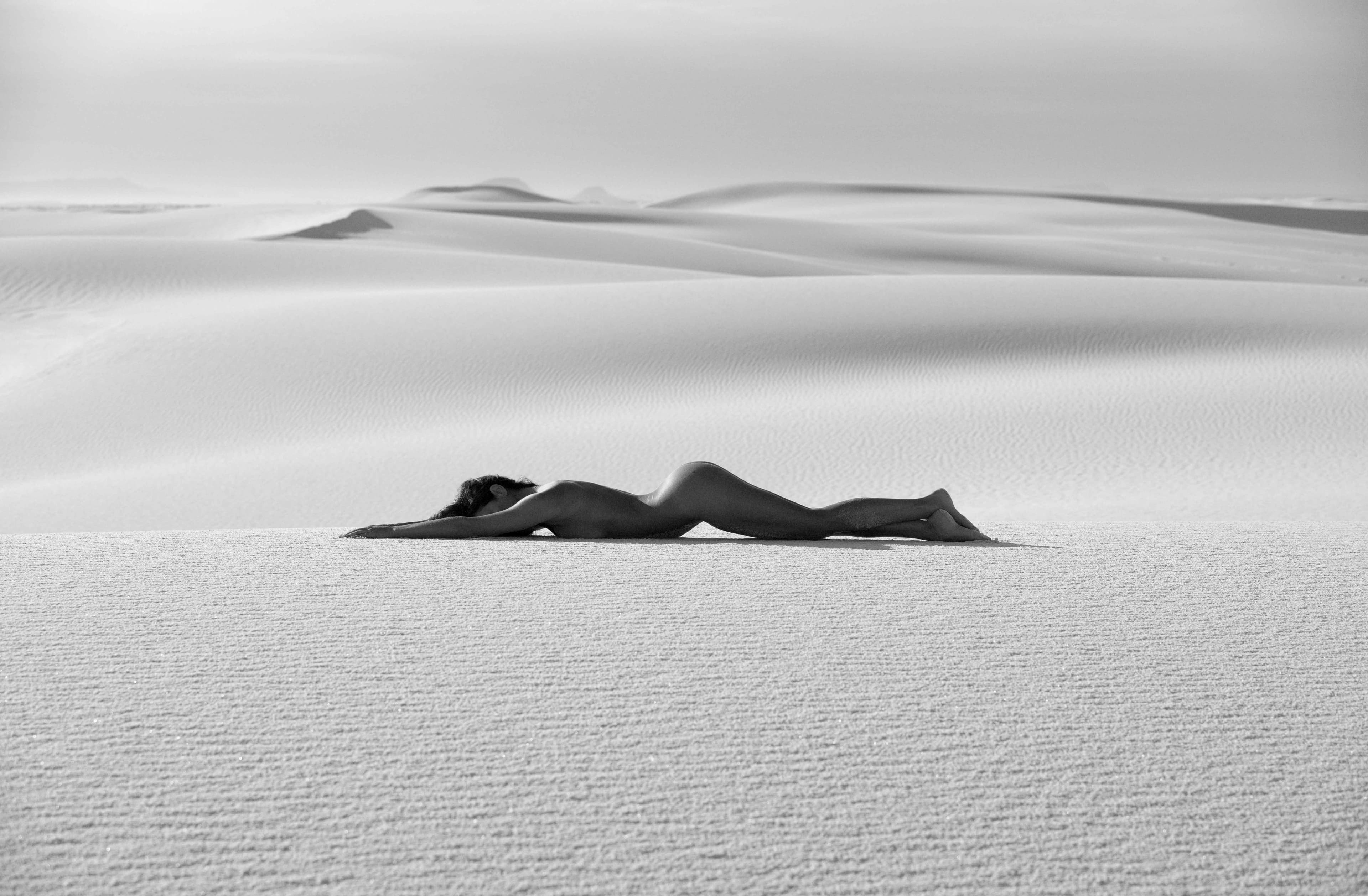 Caroline posing on a white sand dune in the early morning light